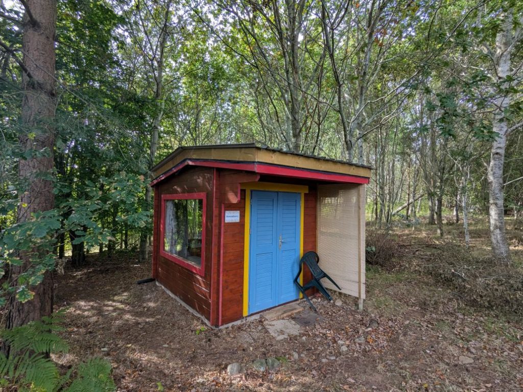 Accommodation for volunteers in wooden off-grid cabin in the woods.